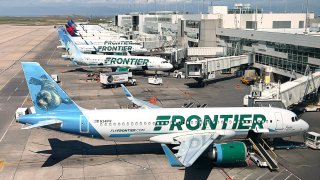 Frontier Airlines planes are parked at gates in Denver International Airport (DEN) in Denver, Colorado, on August 5, 2023.