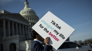 An advocate holds a sign for TikTok following a news conference outside the US Capitol