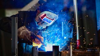 A worker welds at an agricultural machinery manufacturing enterprise in Qingzhou Economic Development Zone in Qingzhou, China, on August 31, 2024.