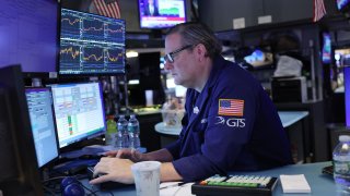 Traders work on the floor of the New York Stock Exchange during morning trading on Sept. 23, 2024.