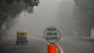 TOPSHOT – A rickshaw drives along a road under heavy smog conditions, in New Delhi