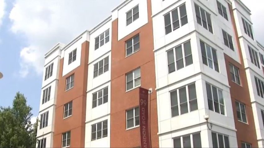 A white and brick apartment building. A red banner on the side reads "99 Shandon"