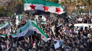 FILE - Syrians celebrate