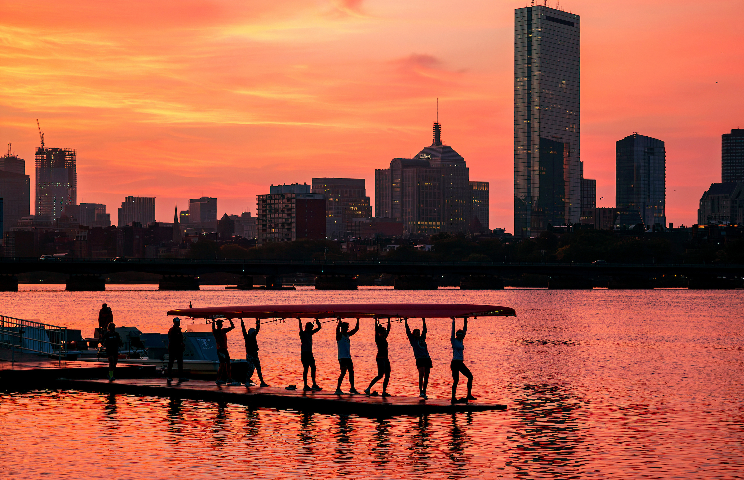 Sept. 17, 2024: The MIT crew team is framed by sunrise tinted red by western wildfires.