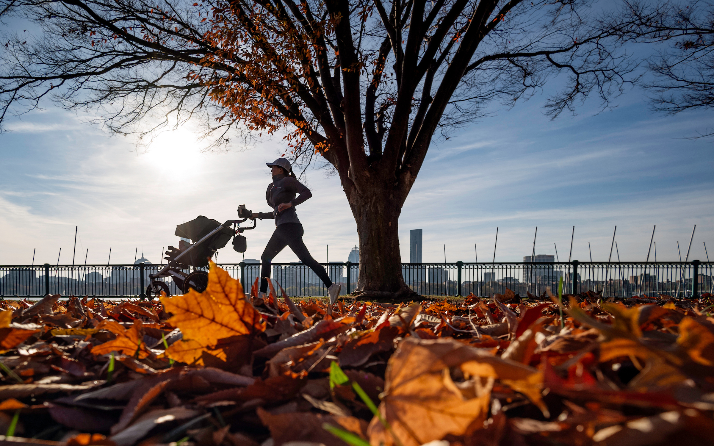 Oct. 31, 2024: A jogger makes her way along a colorful Memorial Drive in Cambridge.