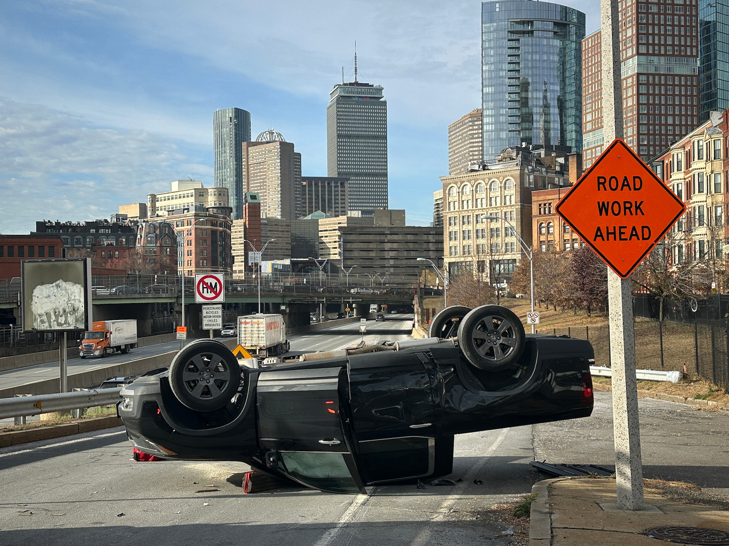 Dec. 9, 2024: A two-car crash caused this vehicle to flip on the on-ramp to the Mass. Pike west at Arlington Street. Non-life threatening injuries were reported.