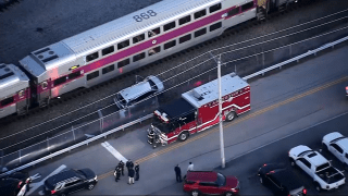 A damaged vehicle next to an MBTA Commuter Rail train and a fire truck in Abington, Massachusetts, on Monday, Dec. 2, 2024.