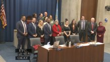 The members of Boston City Council, including, at right, Tania Fernandes Anderson, pose for a picture with the team behind a coffee shop departing City Hall during the Wednesday, Dec. 11, 2024, meeting.