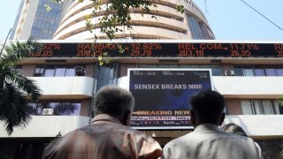 Indian onlookers watch the Bombay Stock Exchange (BSE) digital broadcast outside the BSE in Mumbai on October 24, 2008. I