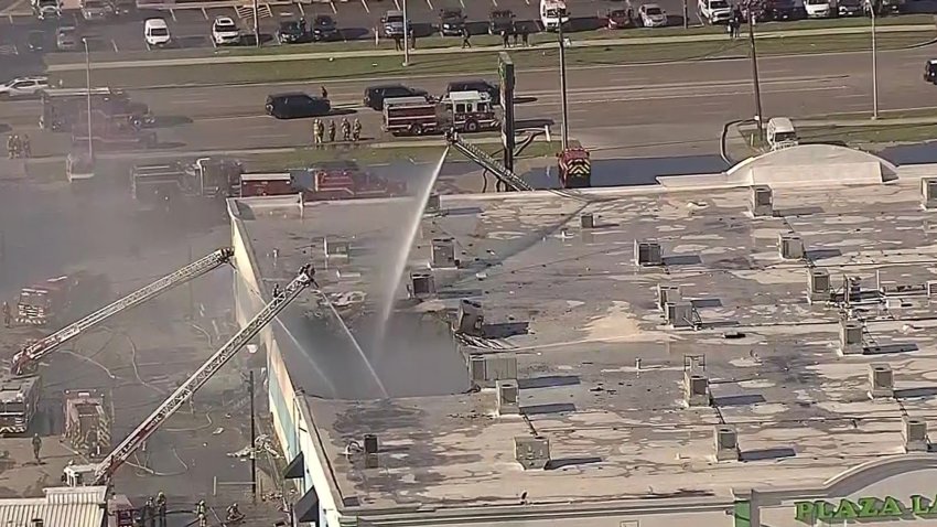 Dallas firefighters battle a fire at Plaza Latina on Friday, Jan. 3, 2025.