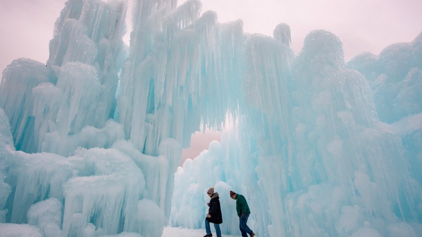 TOPSHOT – People explore the ice walls, trails and caverns at Ice Castles in North Woodstock, New Hampshire on February 1, 2024. Founder Brent Christensen, crafted his first icy creation in the front yard of his home to bring happiness and joy to his children. Since 2011, Ice Castles has been dedicated to creating a world of ice caves, frozen waterfalls, and glaciers formed into archways, caverns, slides, and tunnels. (Photo by Joseph Prezioso / AFP) (Photo by JOSEPH PREZIOSO/AFP via Getty Images)