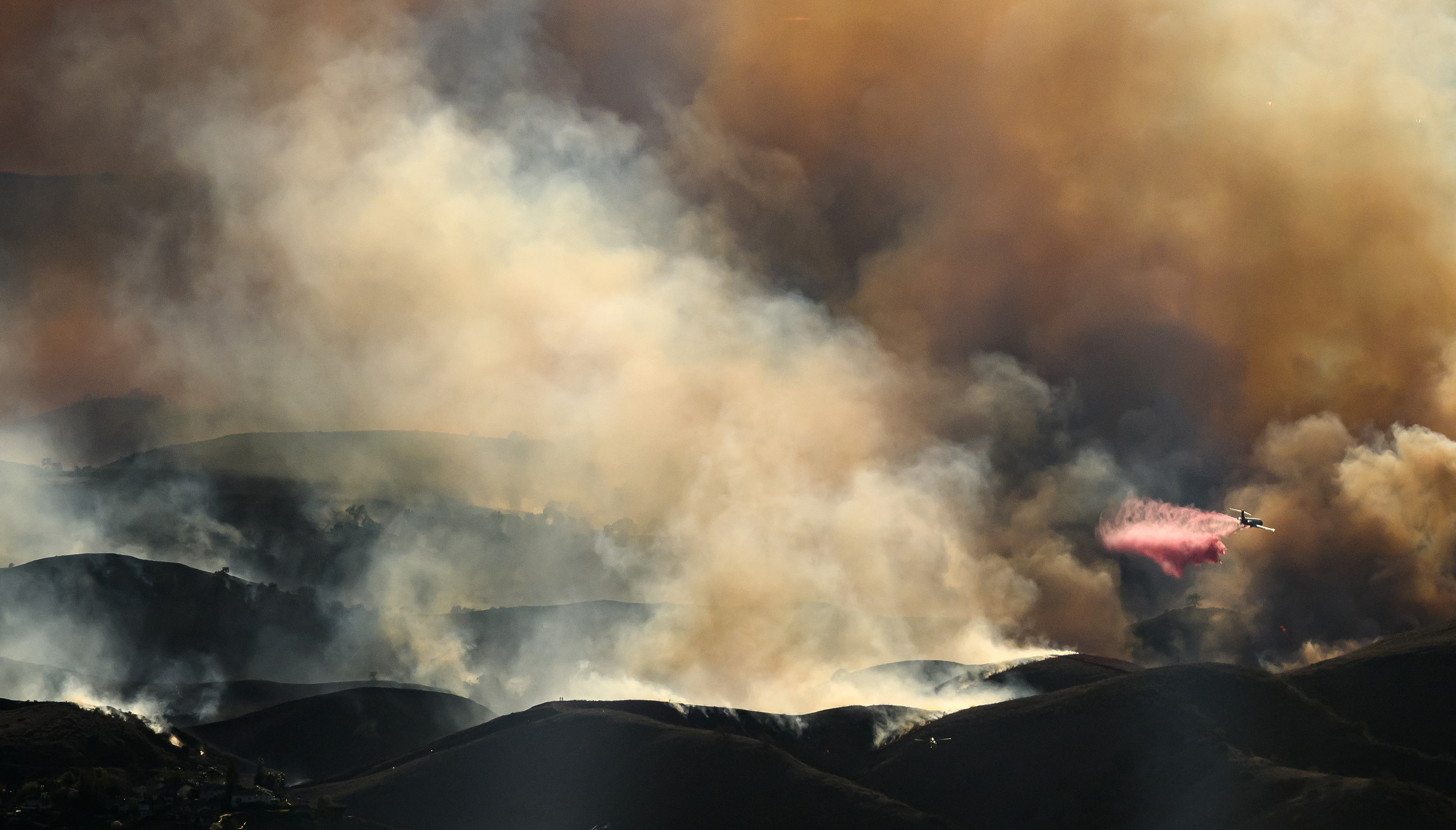 An air tanker drops fire retardant on the Kenneth fire in the Calabasas area on Jan. 9, 2025.