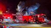 Police officers rescue 3 people stranded on the roof of a burning building in NH